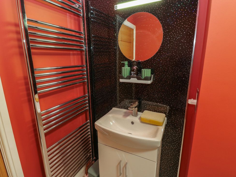 A bathroom with a sink and heated towel rail at No.1 Spa Mill Lodge in Huddersfield