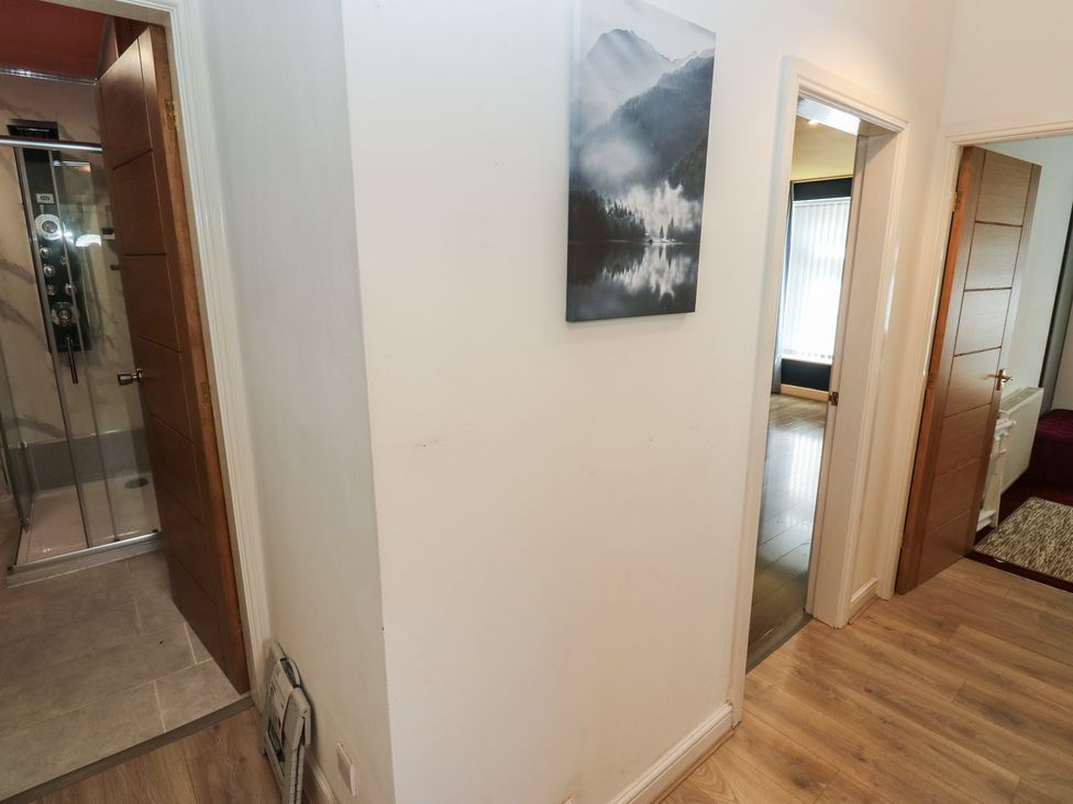 A hallway with doors and a shower area at No.1 Spa Mill Lodge in Huddersfield
