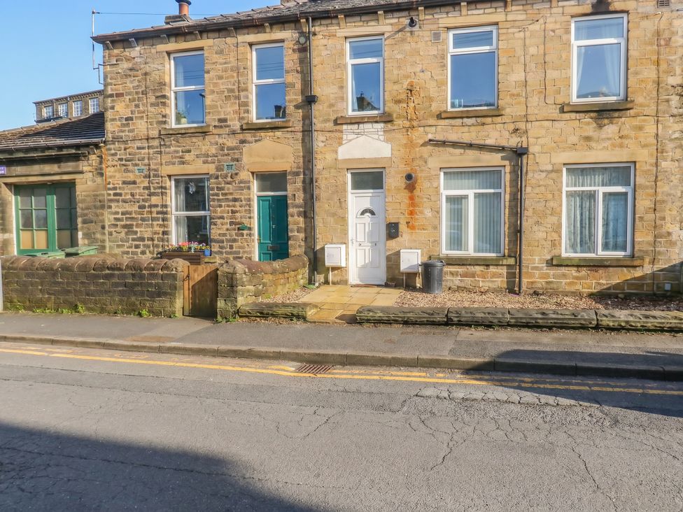 A stone building with a front door and windows at No.1 Spa Mill Lodge in Huddersfield