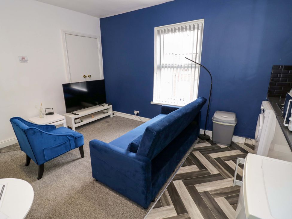 A living room with a television and sofa at 1C Highfield Road - 2 bed Rowley Regis