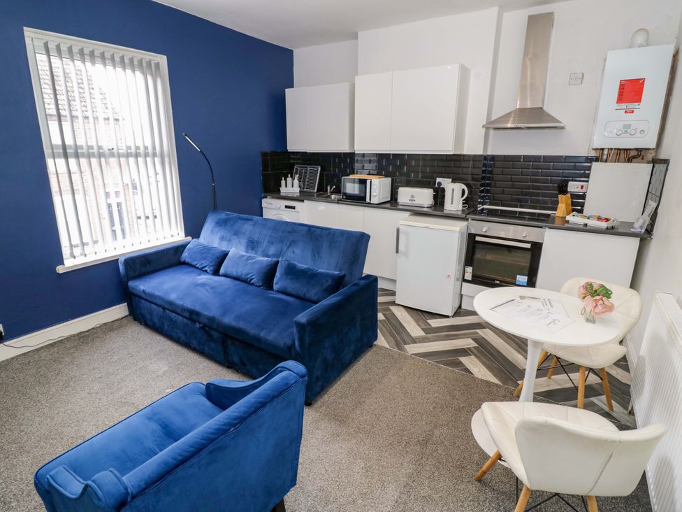 A living room with a kitchen area at 1C Highfield Road - 2 bed Rowley Regis