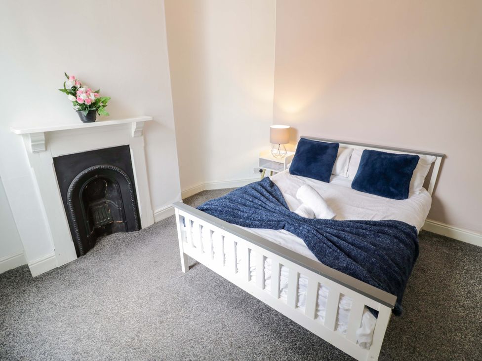 A bedroom with a bed and a decorative plant at 1C Highfield Road - 2 bed in Rowley Regis