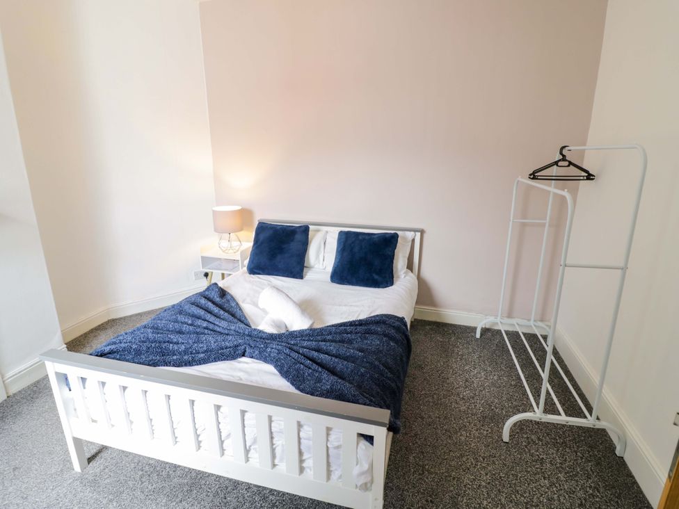 A bedroom with a bed and lamp at 1C Highfield Road - 2 bed Rowley Regis