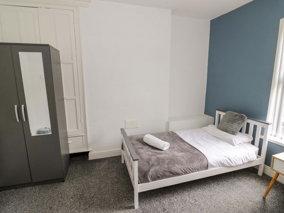 A bedroom with a bed and wardrobe at 1C Highfield Road - 2 bed Rowley Regis