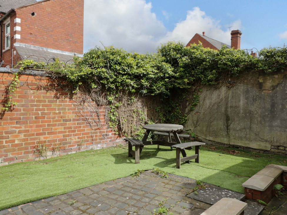 A garden with a table and benches at 1C Highfield Road - 2 bed Rowley Regis
