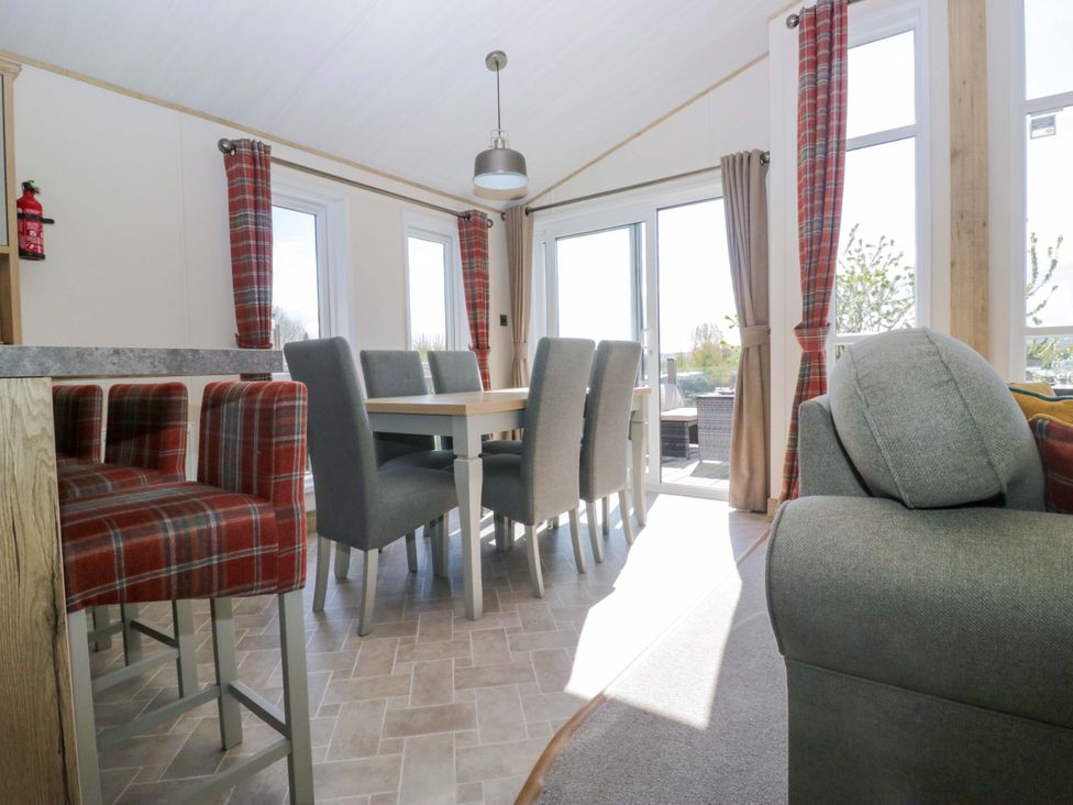 A dining room with a table and chairs at Borwick Heights 17 Carnforth