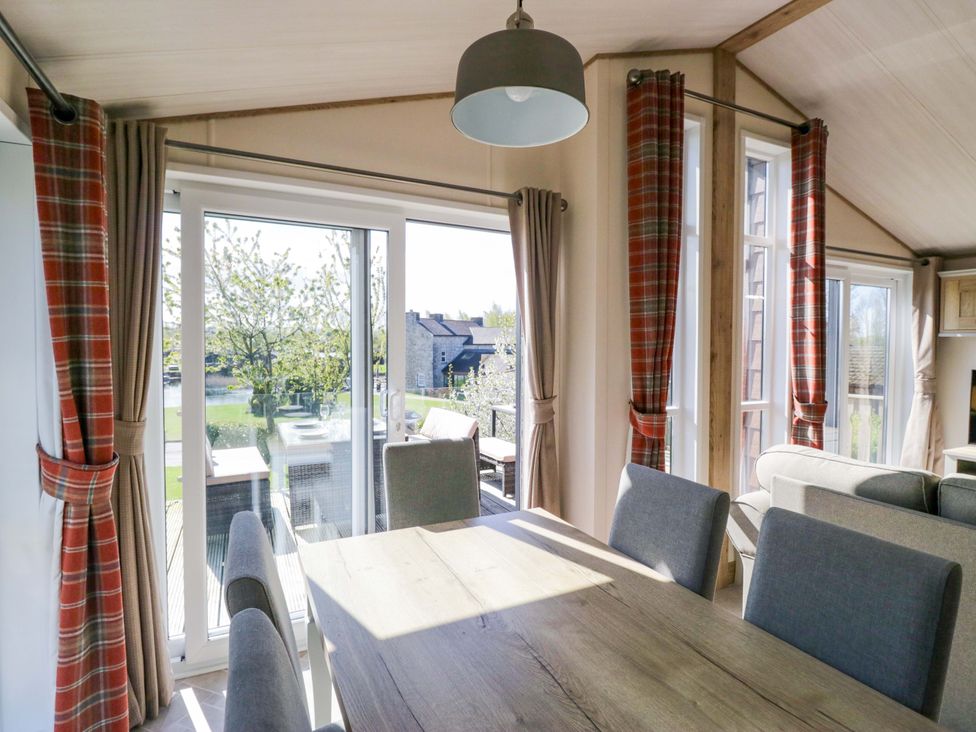 A dining room with a large table and chairs at Borwick Heights 17 in Carnforth