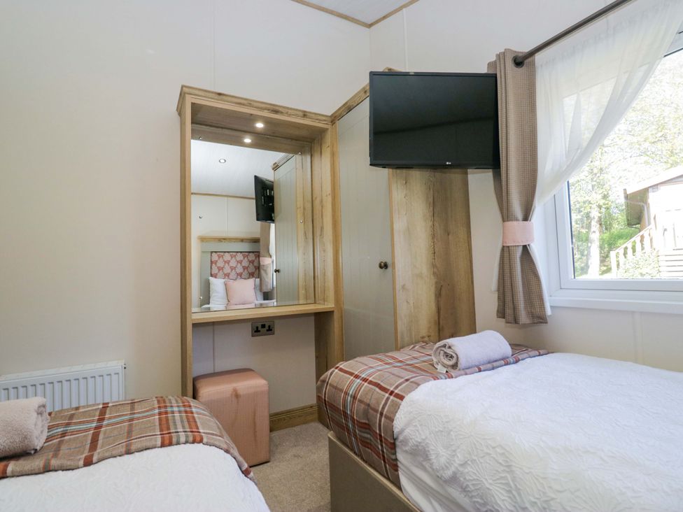 A bedroom with two beds and a dressing table at Borwick Heights 17 Carnforth