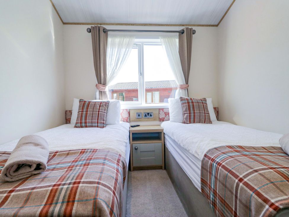 A bedroom with two beds and a window at Borwick Heights 17 Carnforth