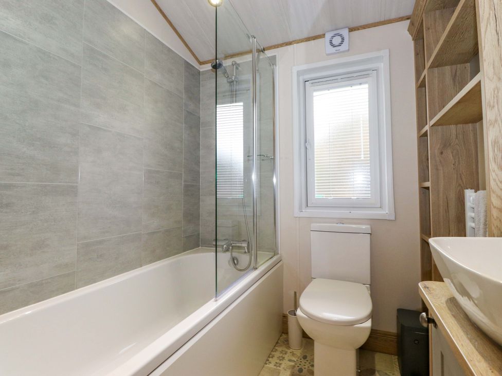 A bathroom with a bathtub and shower at Borwick Heights 17 Carnforth