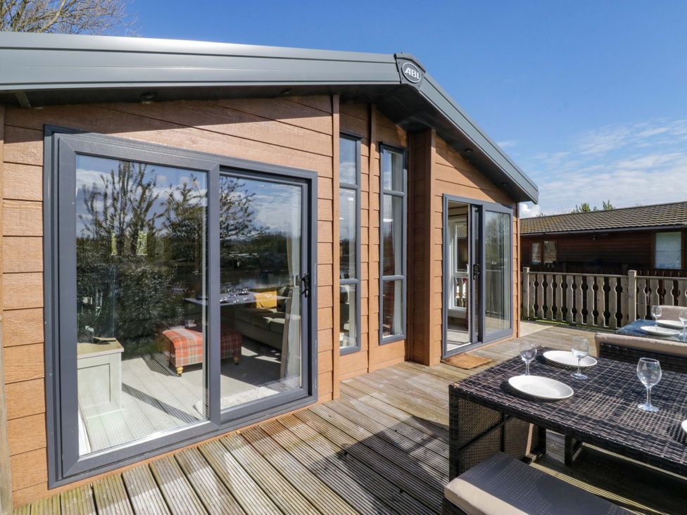 An outdoor space with a table and chairs at Borwick Heights 17 Carnforth