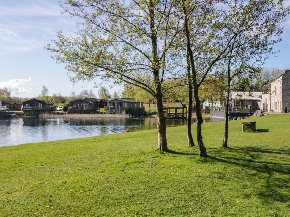 A view of trees and water with houses at Borwick Heights 17 Carnforth