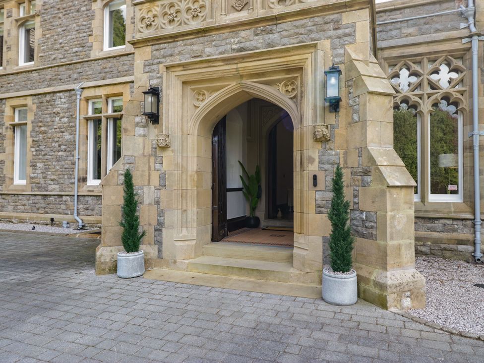 An entrance with a stone door and planters at Brettargh Holt Mansion near Levens