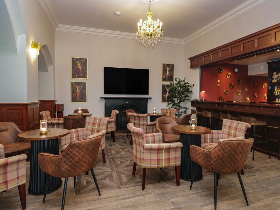 A lounge with chairs and tables at Brettargh Holt Mansion near Levens