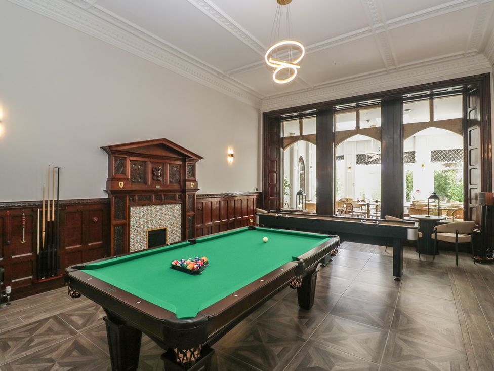 A game room with pool table and seating at Brettargh Holt Mansion near Levens