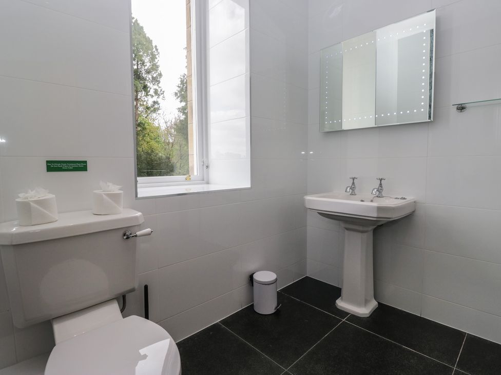 A bathroom featuring a toilet and a sink at Brettargh Holt Mansion near Levens