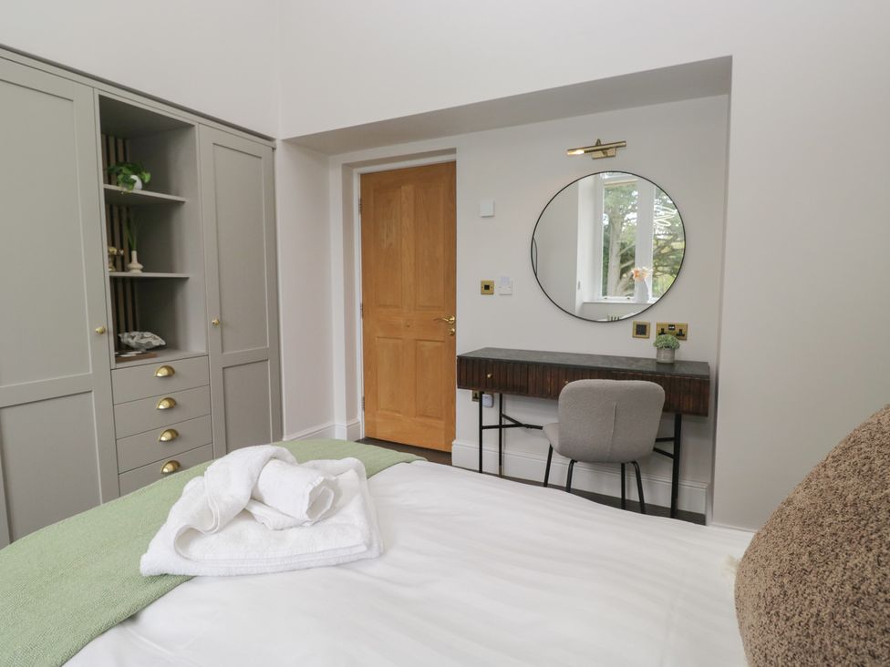 A bedroom featuring a bed, wardrobe, desk, and chair at Brettargh Holt Mansion near Levens
