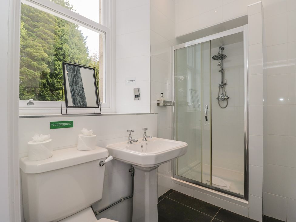 A bathroom with a toilet sink and shower at Brettargh Holt Mansion near Levens