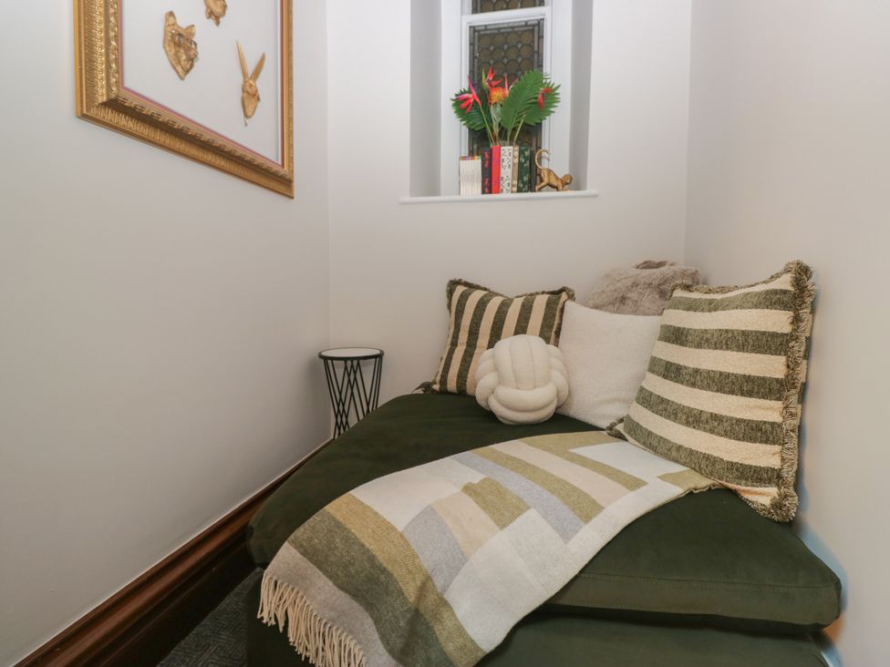 A snug with a couch and decorative pillows at Brettargh Holt Mansion near Levens
