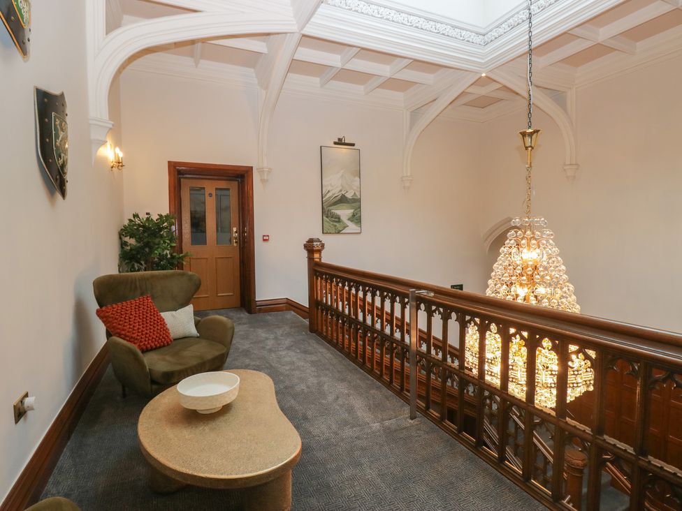 A landing with an armchair and table at Brettargh Holt Mansion near Levens