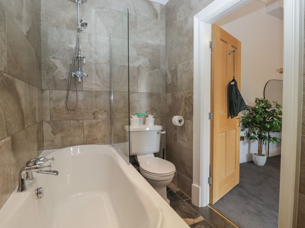 A bathroom featuring a bathtub, shower, and toilet at Brettargh Holt Mansion near Levens