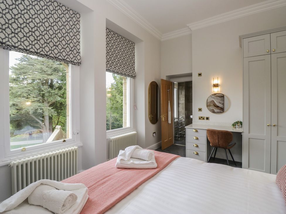 A bedroom with a bed and desk at Brettargh Holt Mansion near Levens