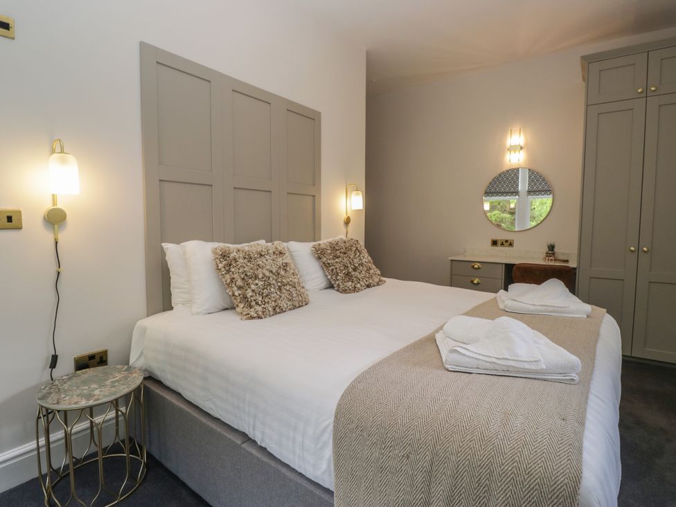 A bedroom with a double bed and wardrobe at Brettargh Holt Mansion near Levens