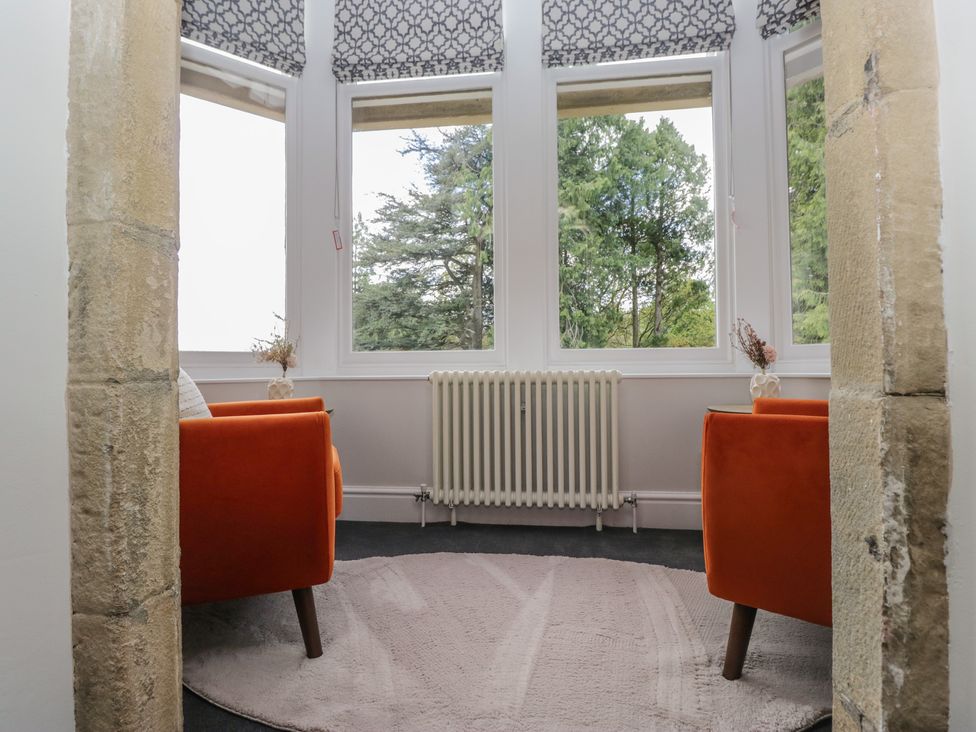 A snug with two chairs and a radiator at Brettargh Holt Mansion near Levens