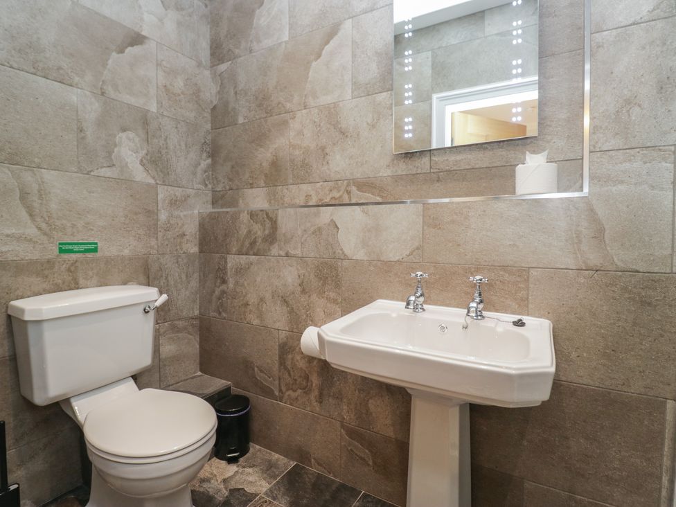 A bathroom with a toilet and sink at Brettargh Holt Mansion near Levens