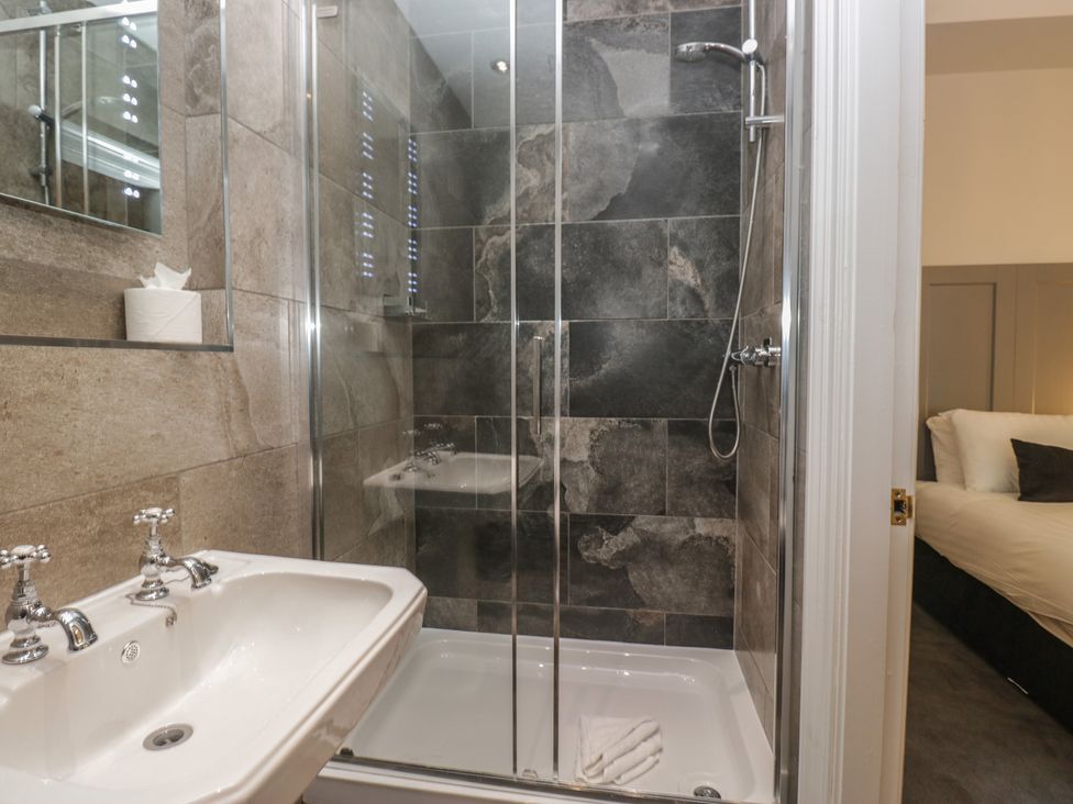 A bathroom featuring a sink and shower at Brettargh Holt Mansion near Levens