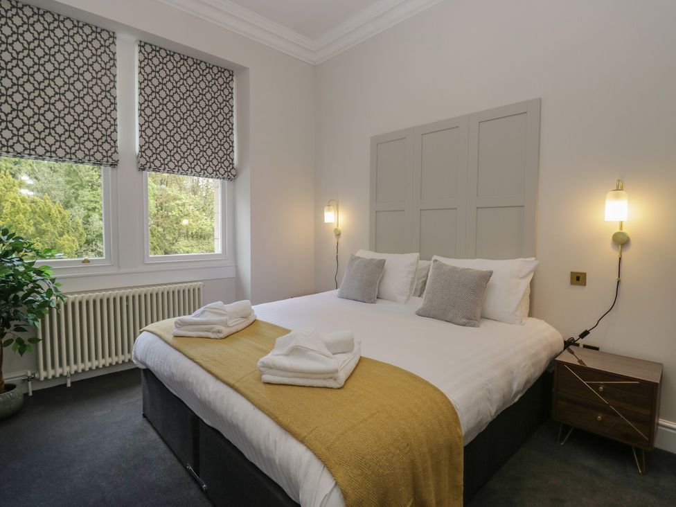 A bedroom with a double bed and nightstand at Brettargh Holt Mansion near Levens