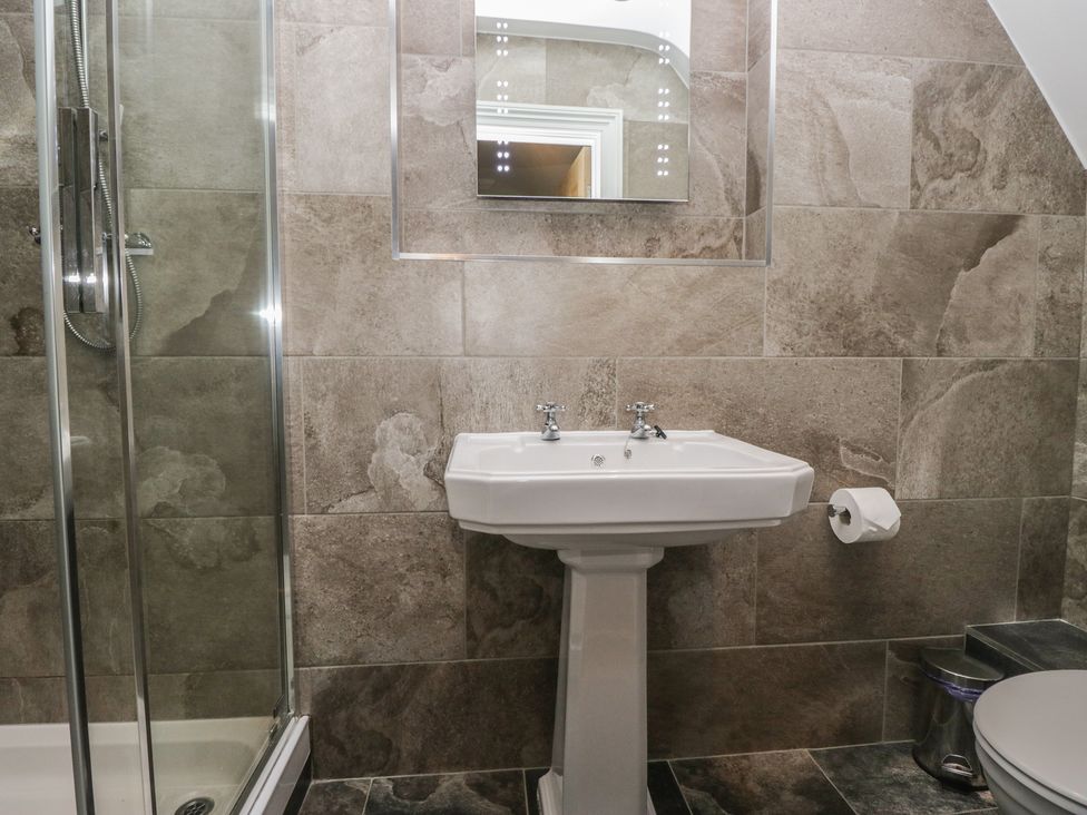 A bathroom with a sink and shower at Brettargh Holt Mansion near Levens