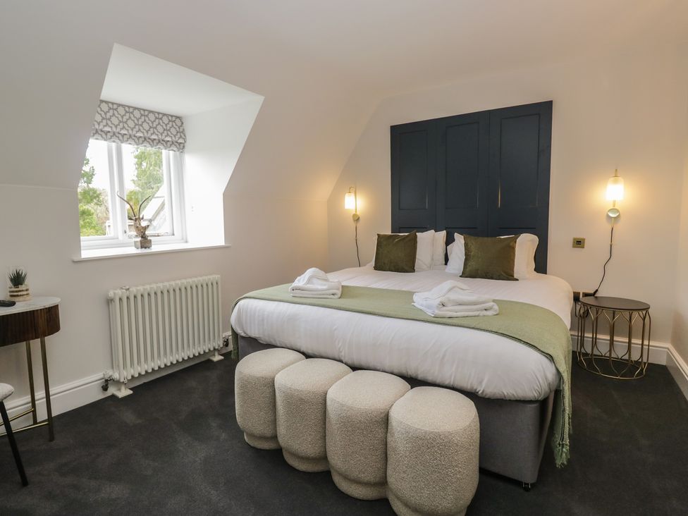 A bedroom with a bed and bedside table at Brettargh Holt Mansion near Levens