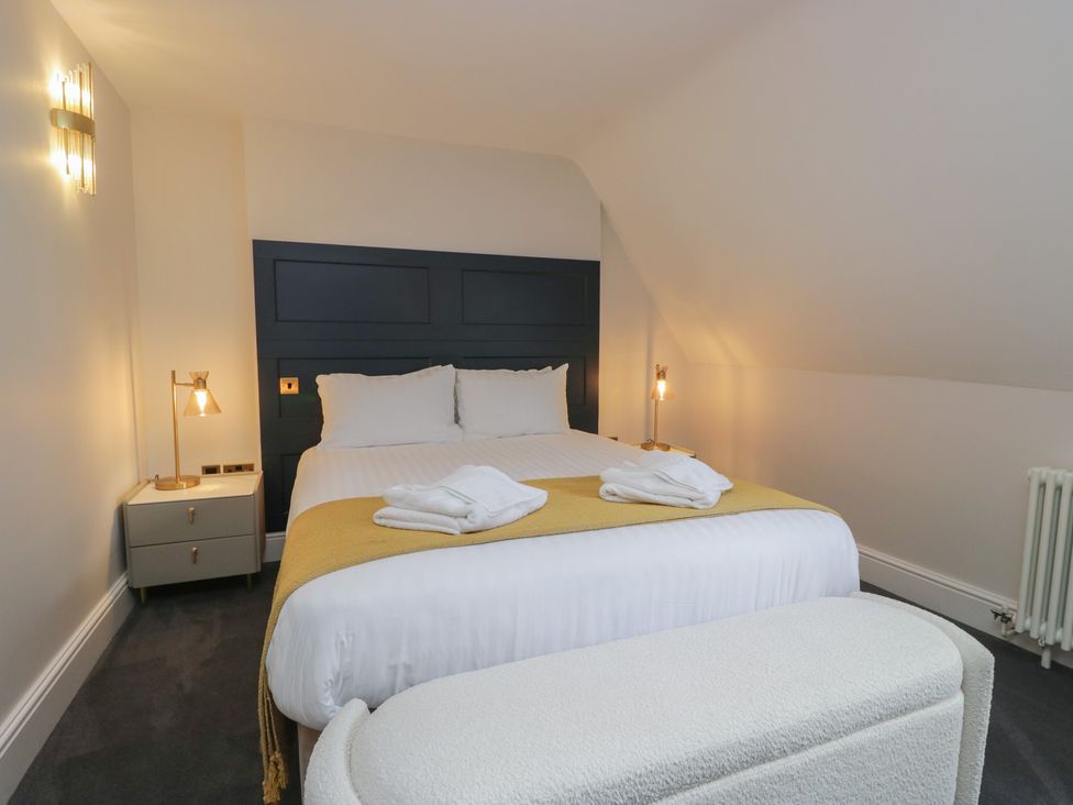 A bedroom with a bed and nightstand at Brettargh Holt Mansion near Levens