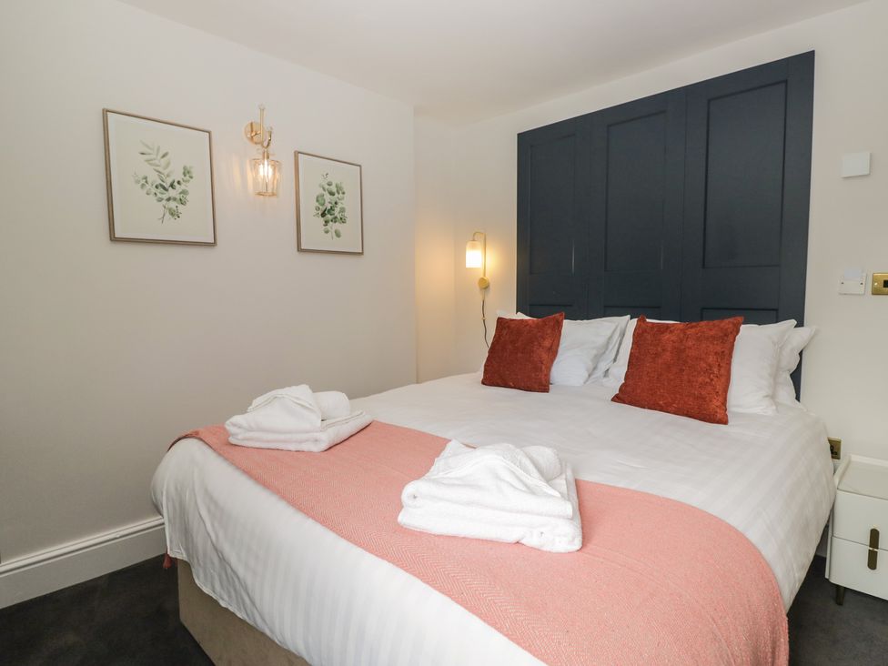 A bedroom with a bed and artwork on the wall at Brettargh Holt Mansion near Levens