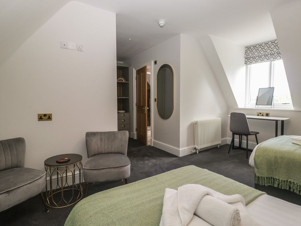 A bedroom with two beds and a desk at Brettargh Holt Mansion near Levens