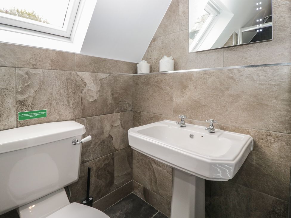 A bathroom with toilet and washbasin at Brettargh Holt Mansion near Levens