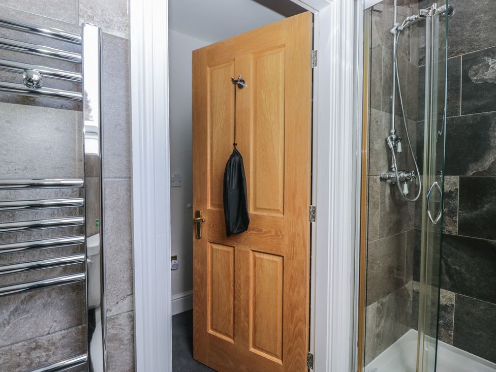 A bathroom with a door and a towel radiator at Brettargh Holt Mansion near Levens
