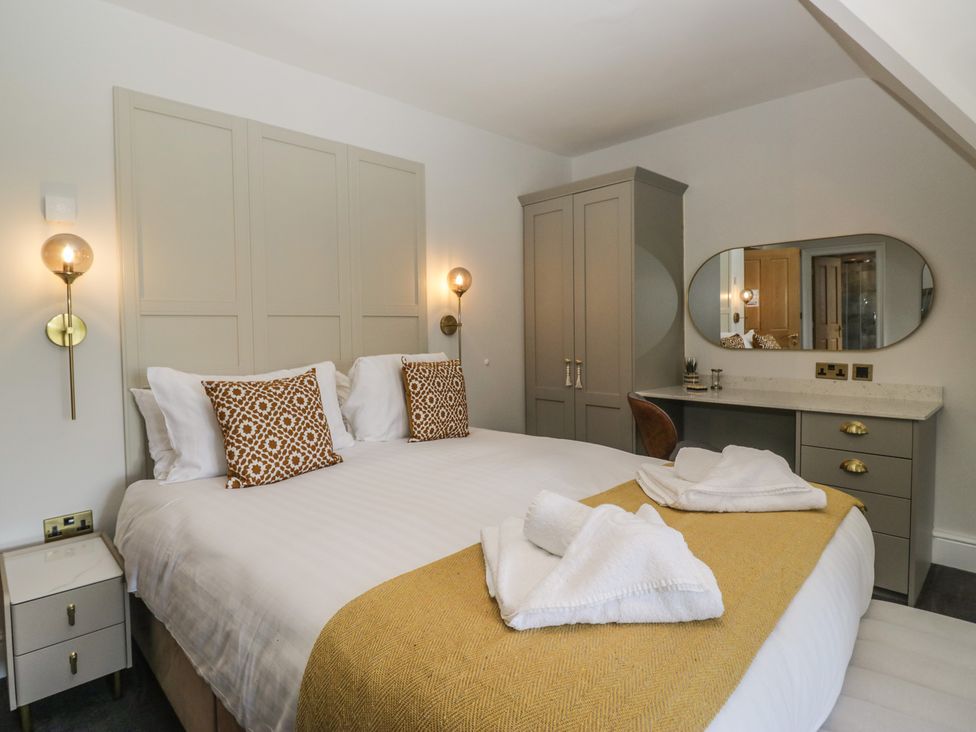 A bedroom with a bed and wardrobe at Brettargh Holt Mansion near Levens