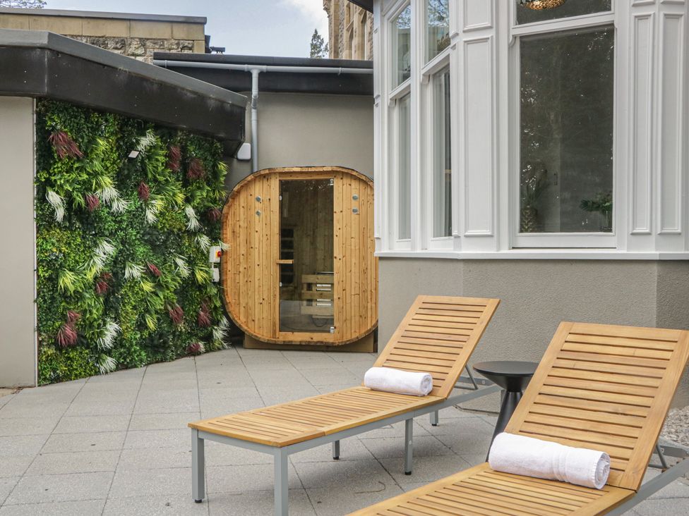 An outdoor space with lounge chairs and a sauna at Brettargh Holt Mansion near Levens
