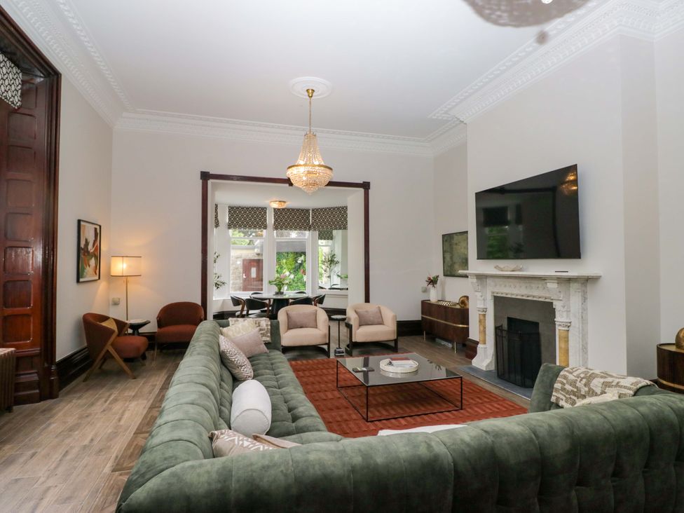 A living room with a television and fireplace at Brettargh Holt Mansion Sleeping 48 near Sizergh, Cumbria