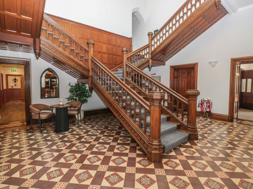 An entryway with a staircase and seating area at Brettargh Holt Mansion 32 near Levens