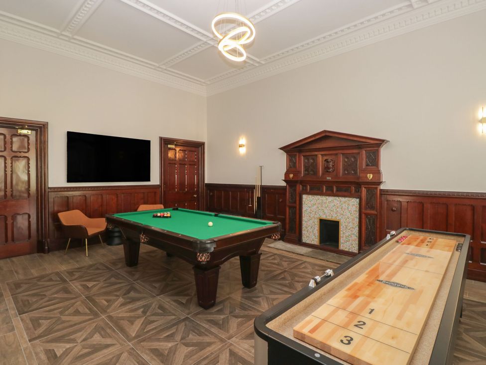 A game room with a pool table and shuffleboard table at Brettargh Holt Mansion 32 near Levens