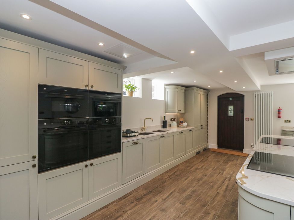 A kitchen with cabinets and appliances at Brettargh Holt Mansion 32 near Levens
