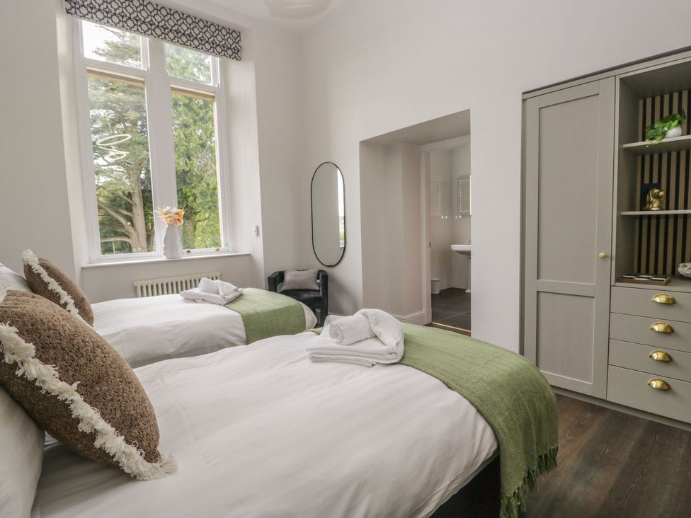 A bedroom with twin beds and a wardrobe at Brettargh Holt Mansion 32 near Levens