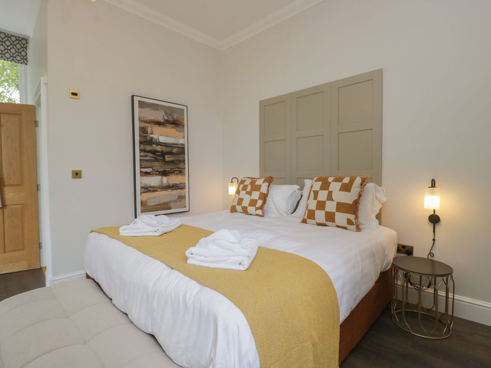 A bedroom with a bed and artwork at Brettargh Holt Mansion 32 near Levens