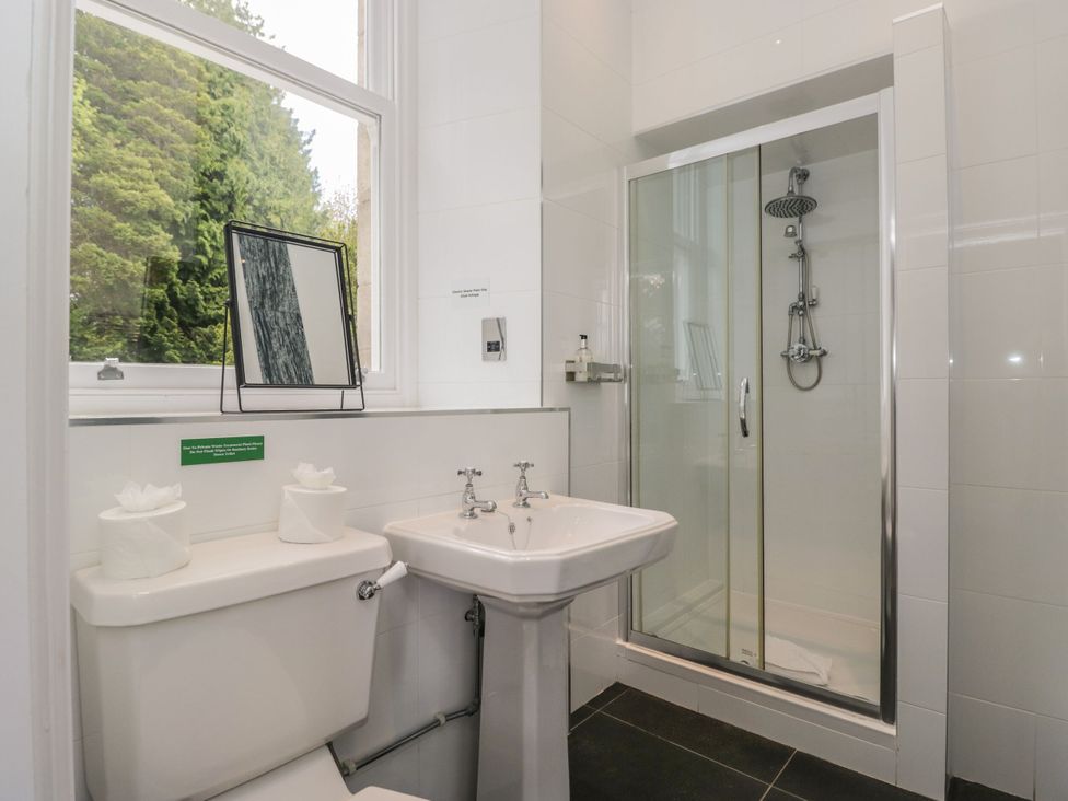 A bathroom featuring a shower, sink, and toilet at Brettargh Holt Mansion 32 near Levens
