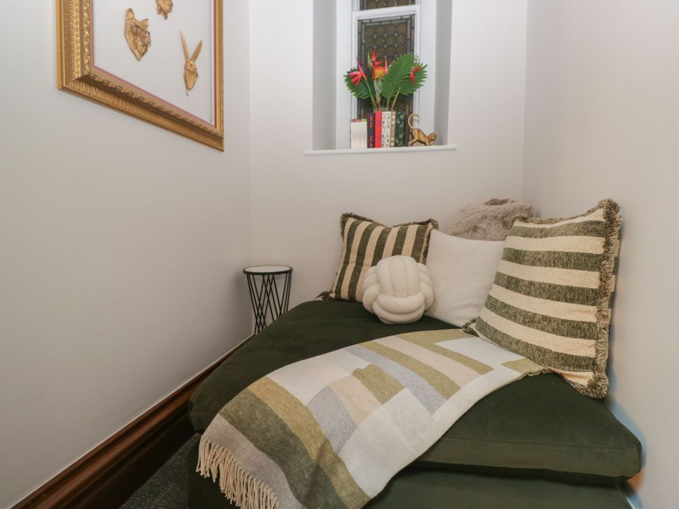 A snug area with a sofa and cushions at Brettargh Holt Mansion 32 near Levens