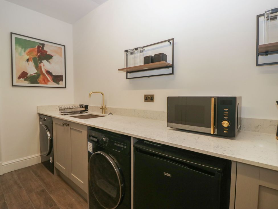 A utility room with appliances and a sink at Brettargh Holt Mansion 32 near Levens