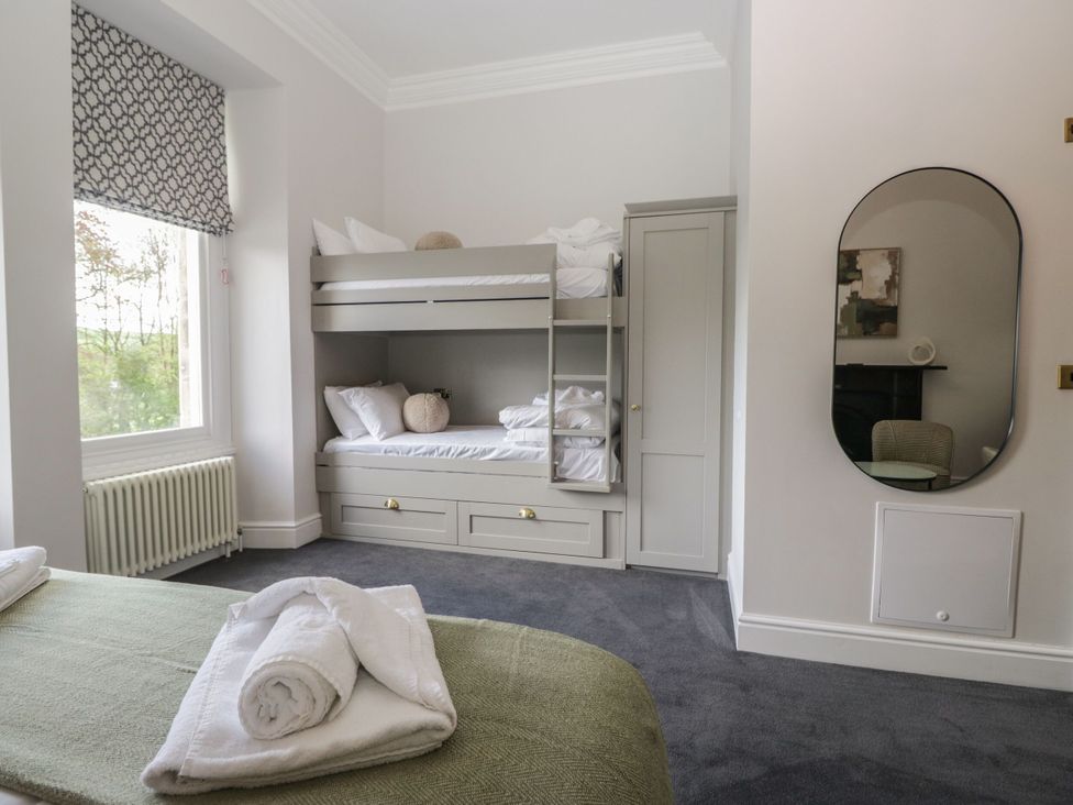 A bedroom with a bunk bed and double bed at Brettargh Holt Mansion 32 near Levens